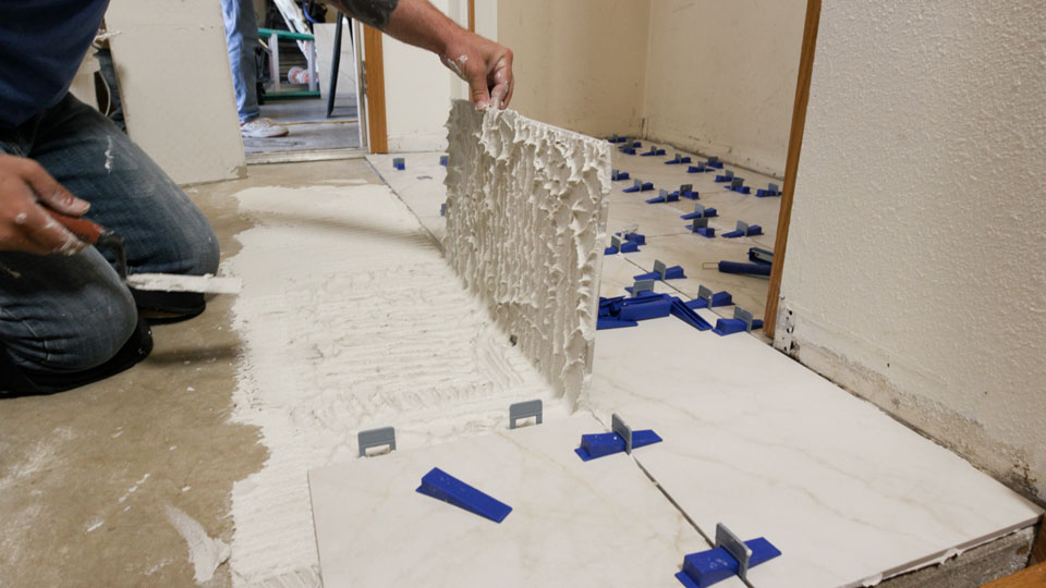 pulling up a tile to check the thinset coverage